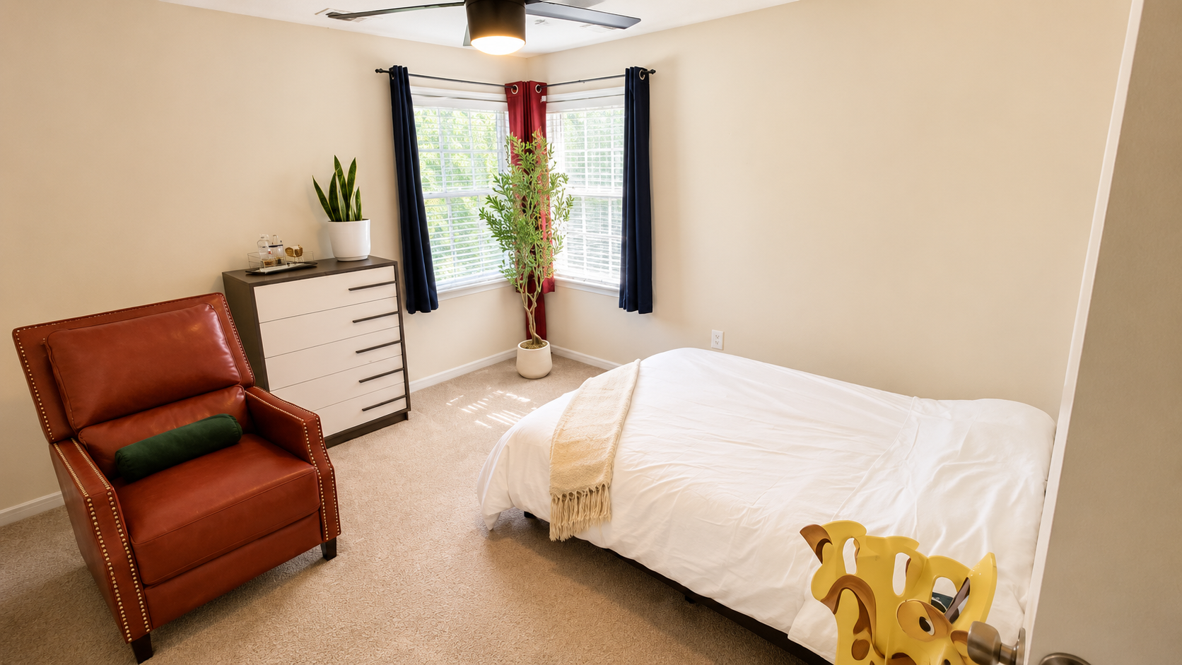 Upstairs guest bedroom with fresh flowers and a writing table at the retreat estate
