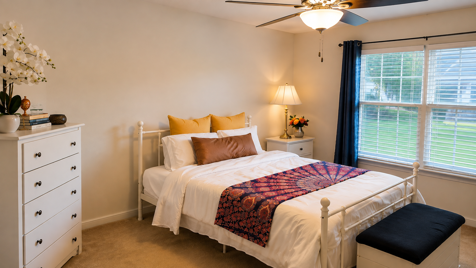 Guest bedroom with a navy bedspread and garden view at the women's retreat estate