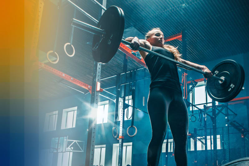 Female trainer lifting weights