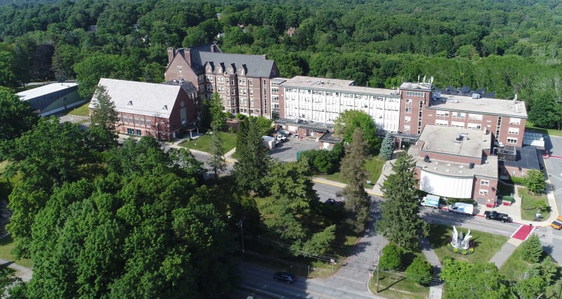 Aerial drone shot of Massbay Community College campus and surrounding woodlands