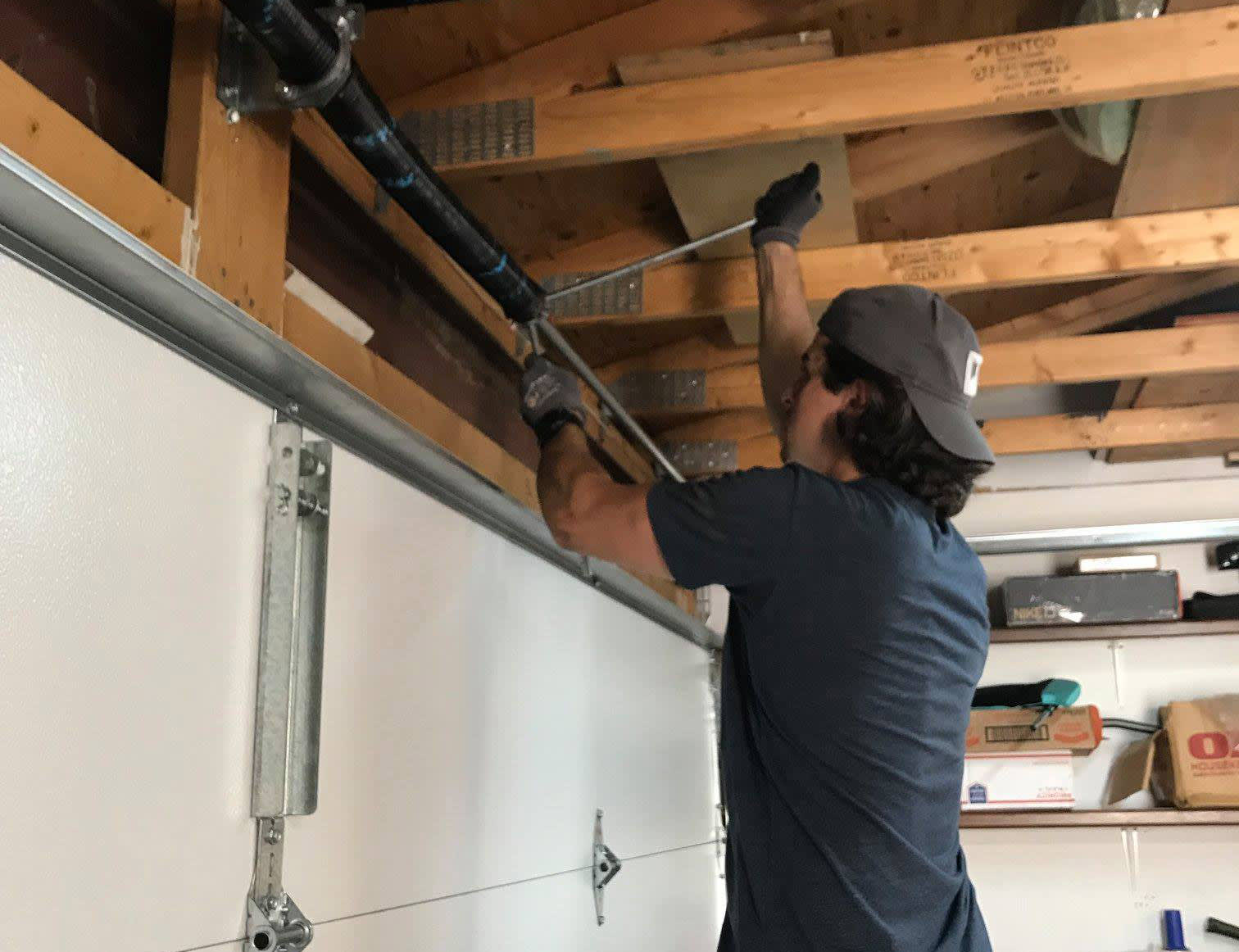 Worker repairing a garage door