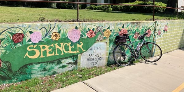 A photo of a bicycle in front of a public mural.