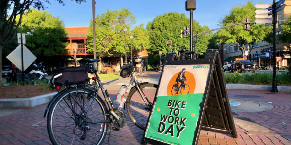 A photo of a bicycle beside a sign saying "BIKE TO WORK DAY."