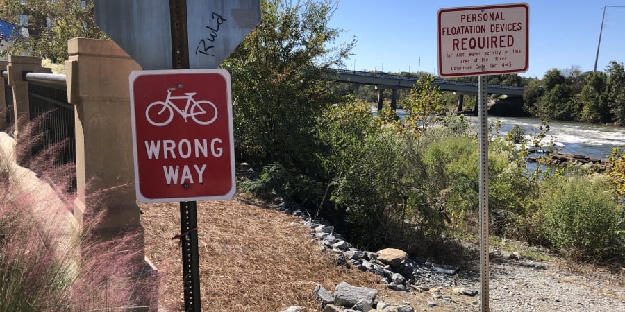 A street sign depicting a bicycle with the text “wrong way.”