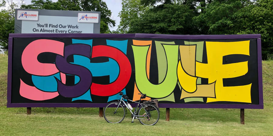 A photo of my bicycle in front of a billboard mural with the words "SOUL SHINE" in stylized lettering.