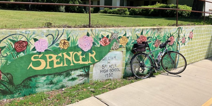 A photo of a bicycle in front of a public mural.