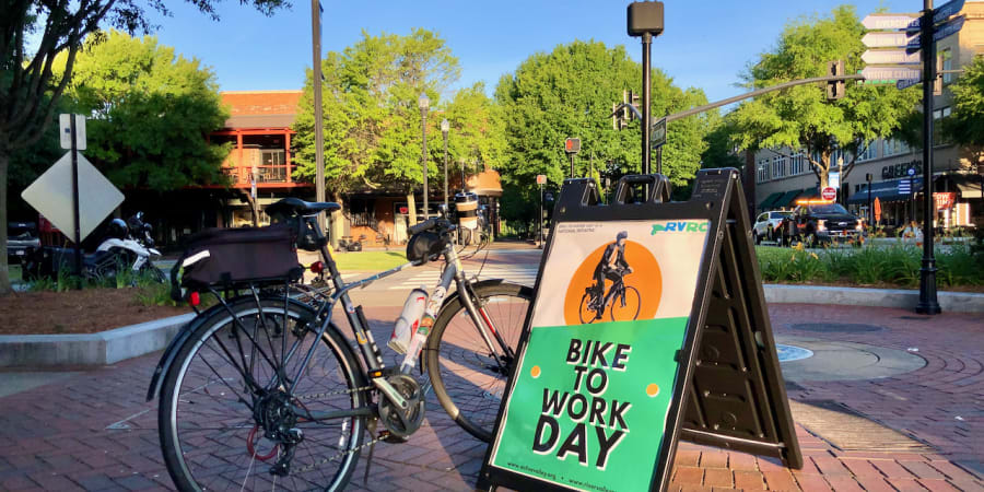 A photo of a bicycle beside a sign saying "BIKE TO WORK DAY."