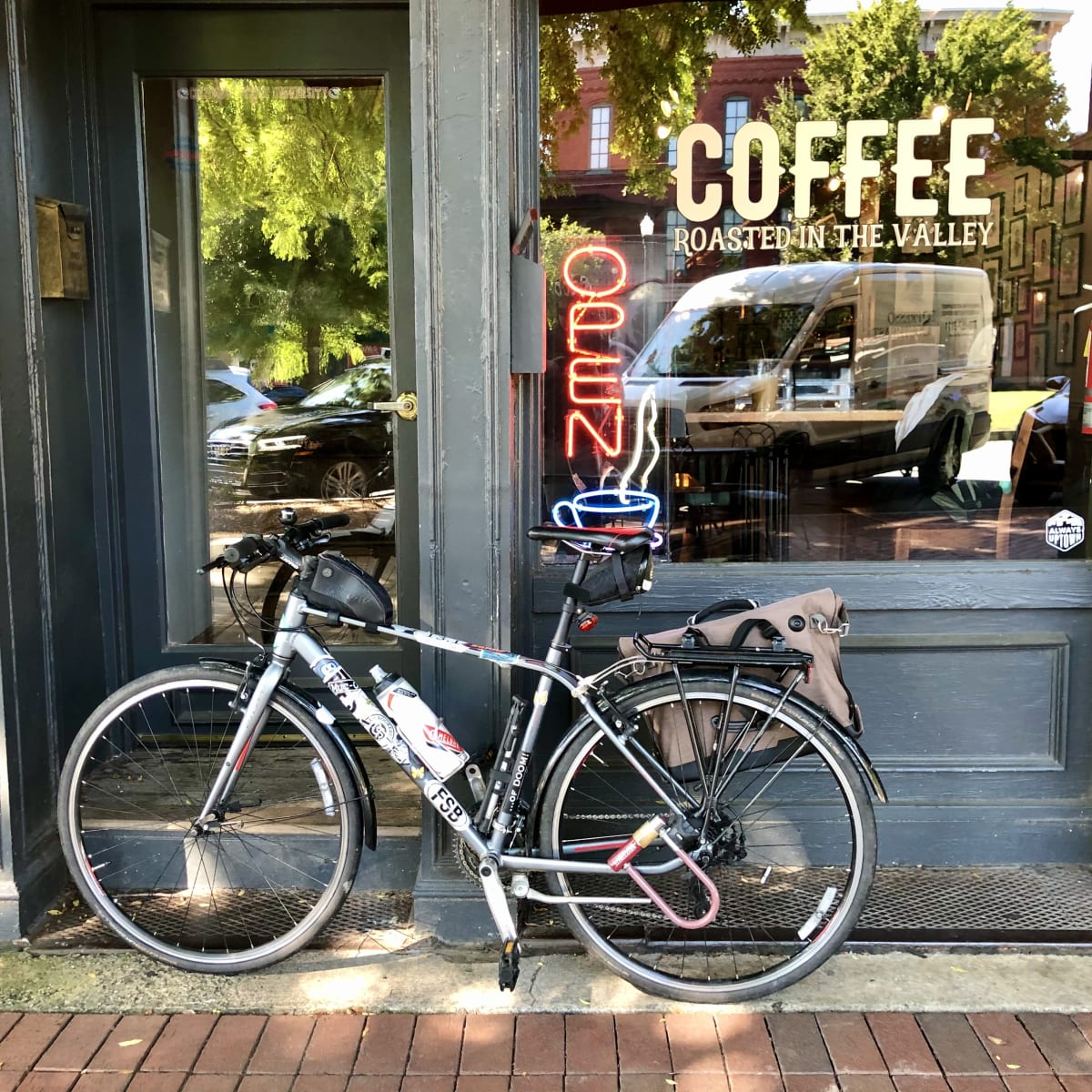 A photo of my bicycle in front of Fountain City Coffee.