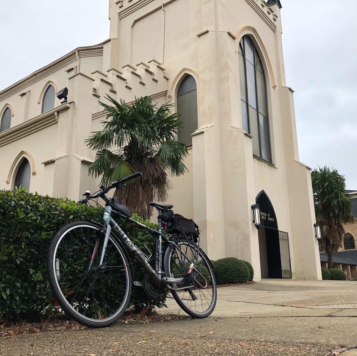 A photo of my bicycle in front of a church.