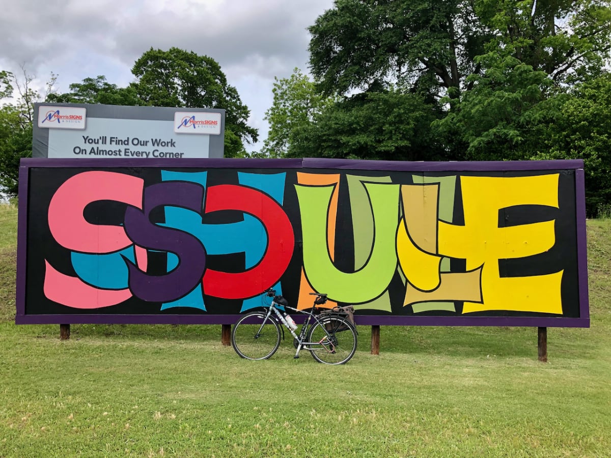 A photo of my bicycle in front of a billboard mural with the words "SOUL SHINE" in stylized lettering.