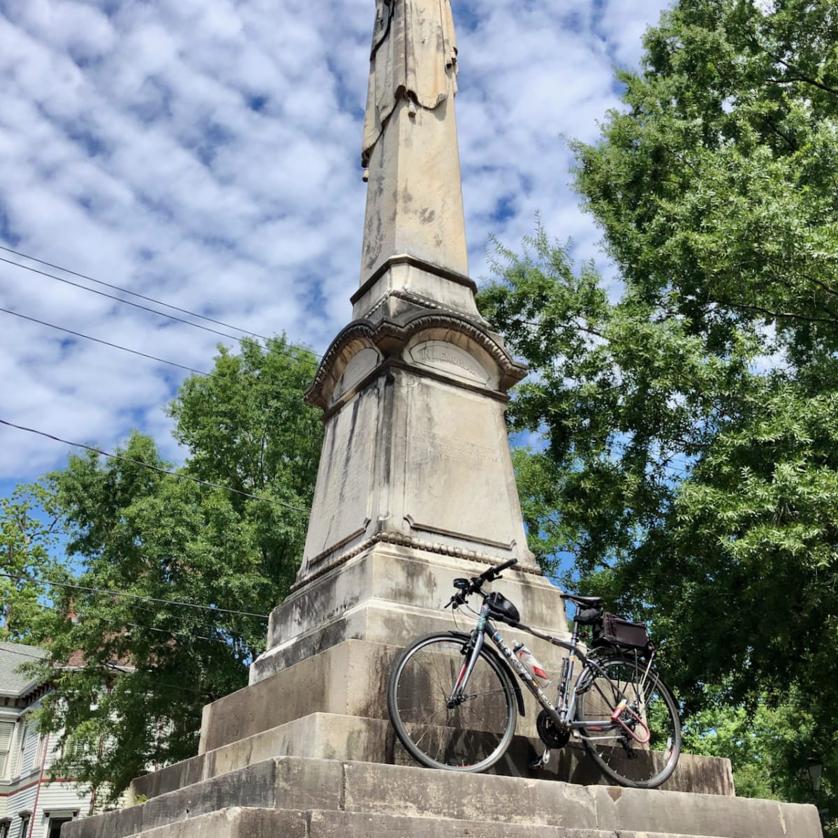 A photo of my bicycle in front of a monument.