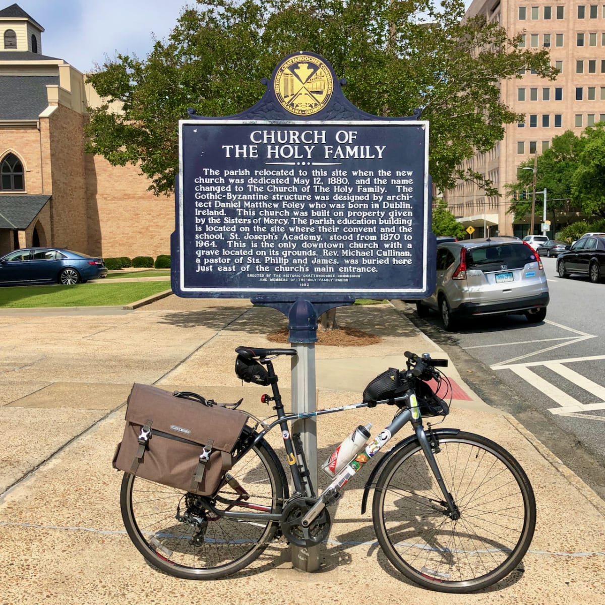 A photo of my bicycle in front of the church's historic marker.