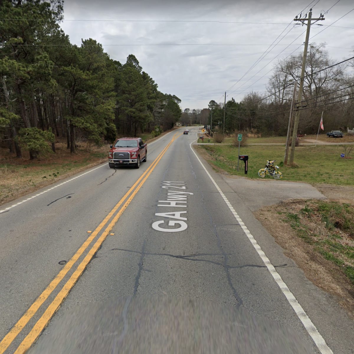 A photo of a rural highway as seen from a car.