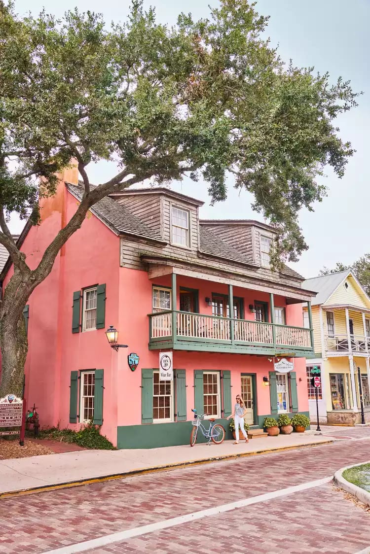 A photo of a woman with a bicycle in St. Augustine.