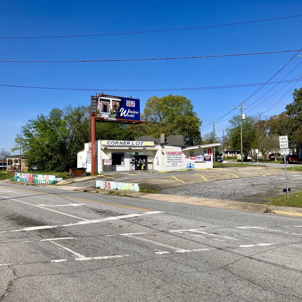 A photo of an empty parking lot with a store that says "Corner Lot."