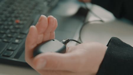 Client holding a tactile BLS buzzer for EMDR therapy