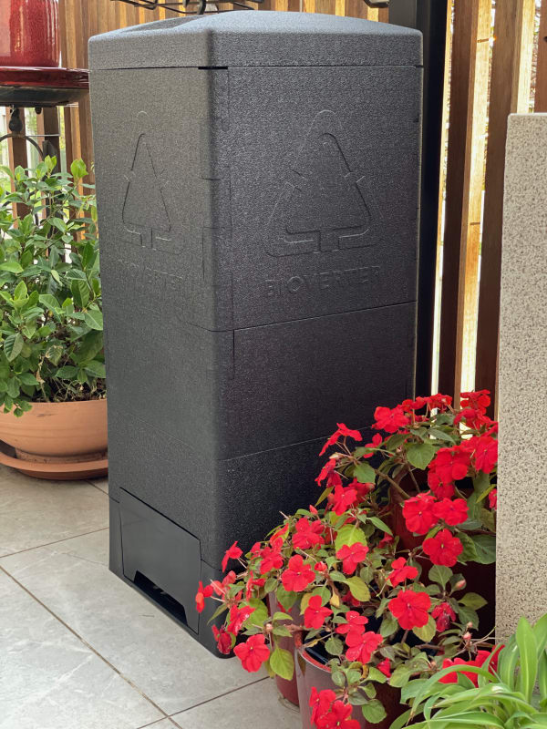 Bioverter unit on patio surrounded by plants