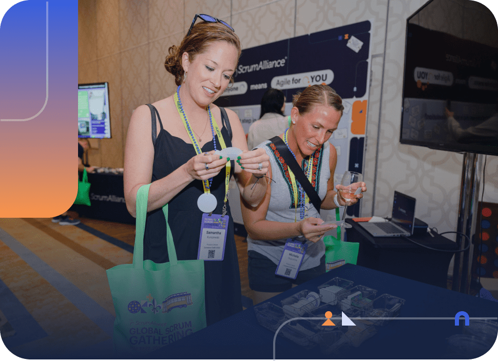2 attendees at a previous Global Scrum Gathering booth