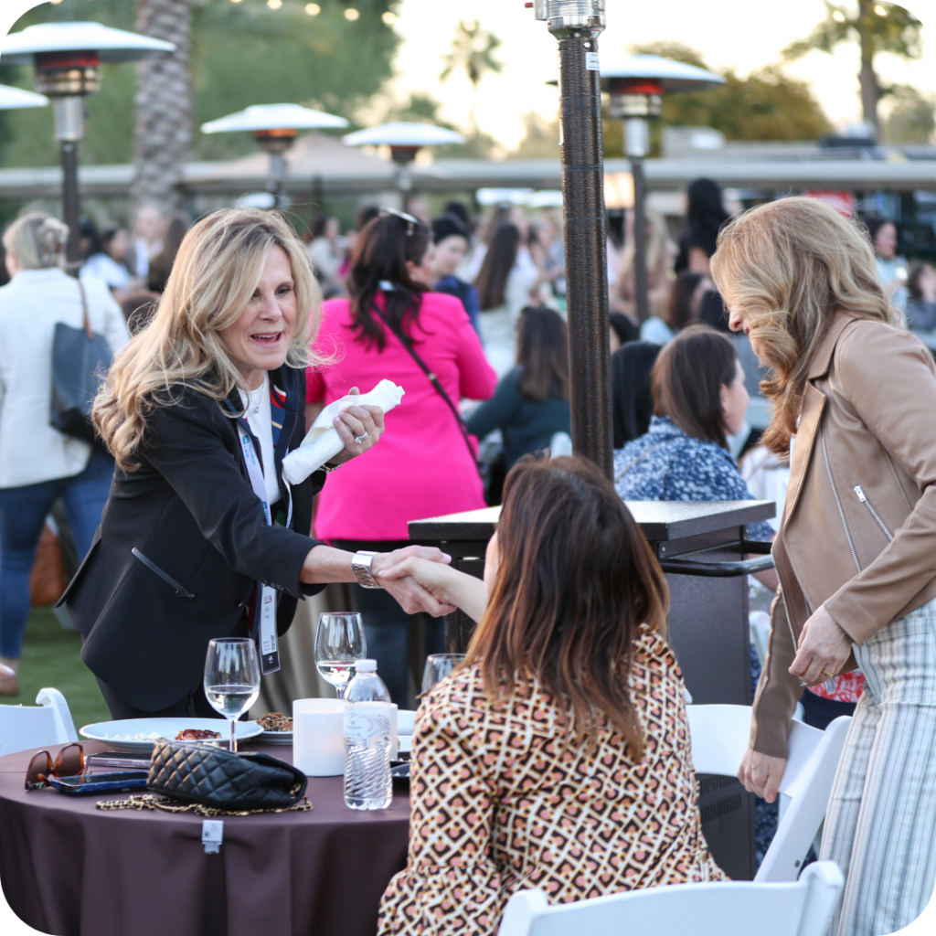 Female leaders shaking hands at the Women’s Private Capital Summit