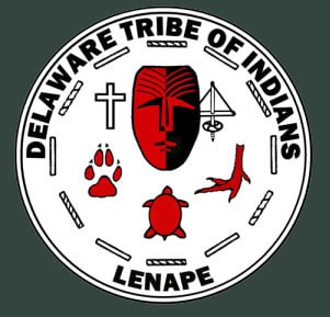 Delaware Tribe of Indians official seal. Dark grey background with a circular black and white seal that depicts tools, a bear paw, a turtle, and a bird foot. The text in the seal reads Delaware tribe of Indians on the top, Lenape on the bottom.