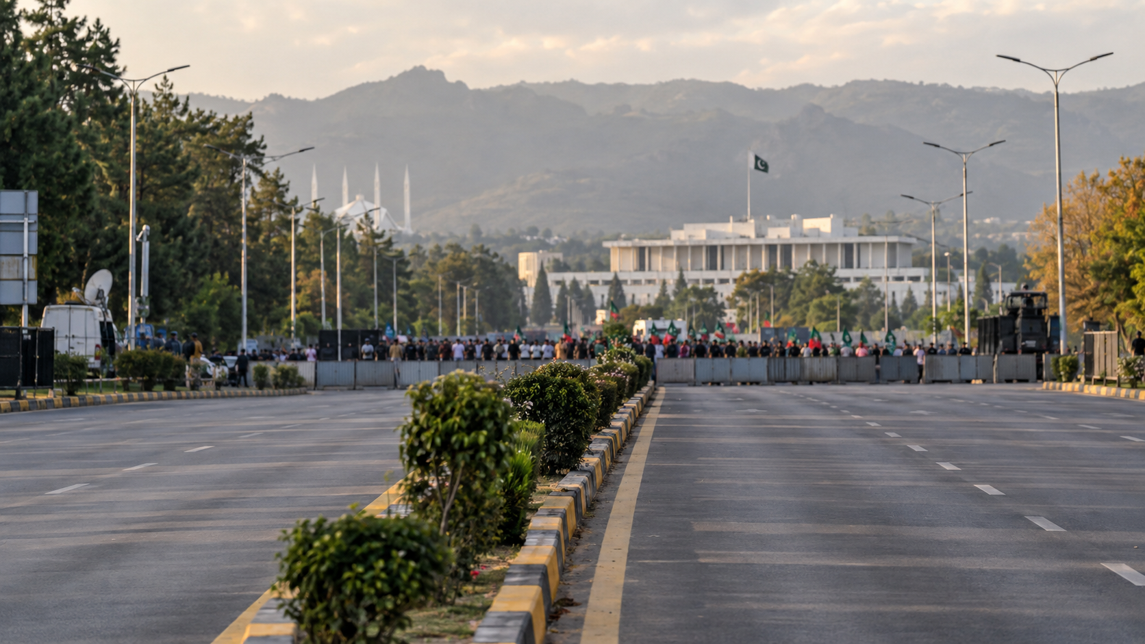 Islamabad avenue with distant peaceful political gathering and security barriers