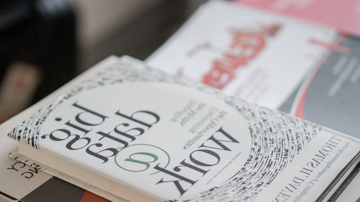 Most UK firms see AI benefits Close-up of books on data analytics and business strategies on a desk.
