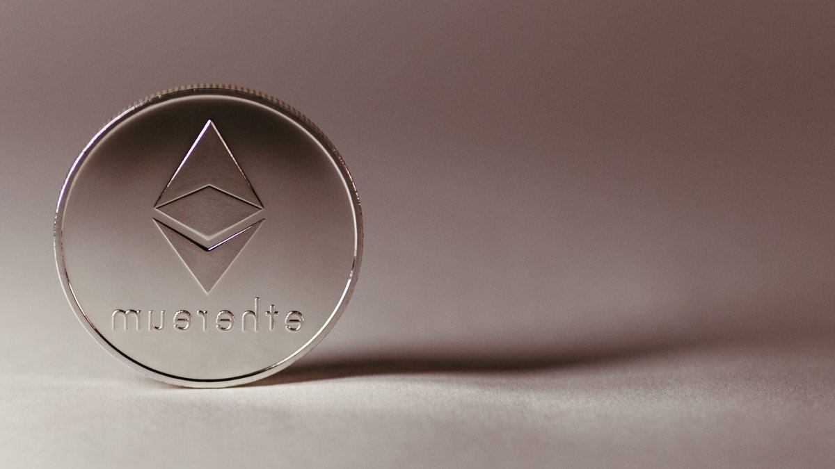 Close-up of a silver Ethereum coin symbolizing digital currency and blockchain technology.