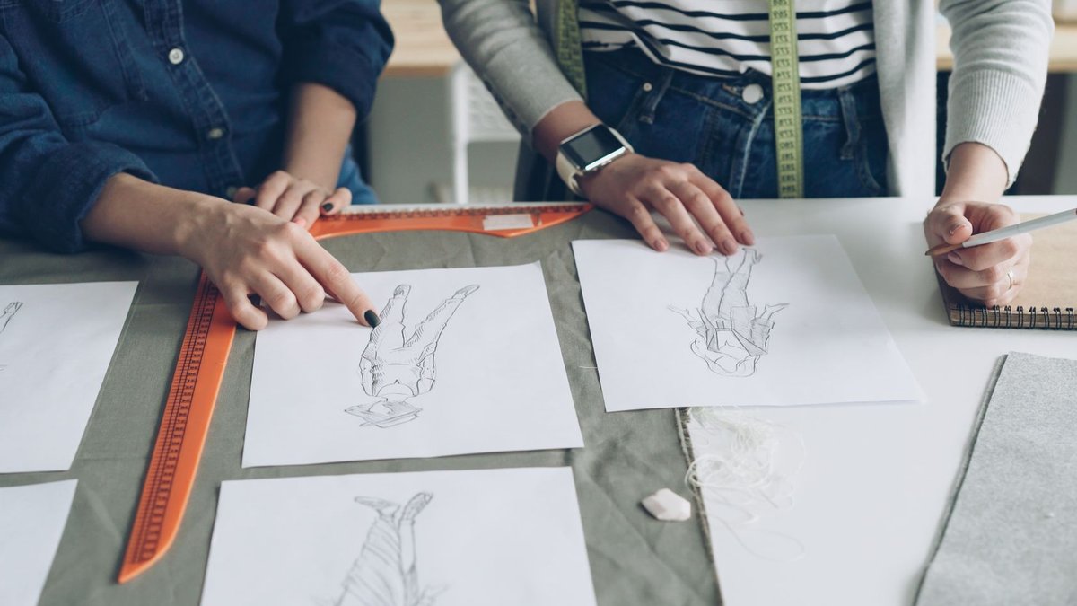 Heidi Caillier Shares Design Advice From AD PRO Dialogues Designers working together on fashion sketches, coordinating design ideas.