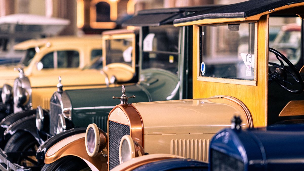 Explore classic and antique cars lined up in an indoor vintage car museum exhibit.