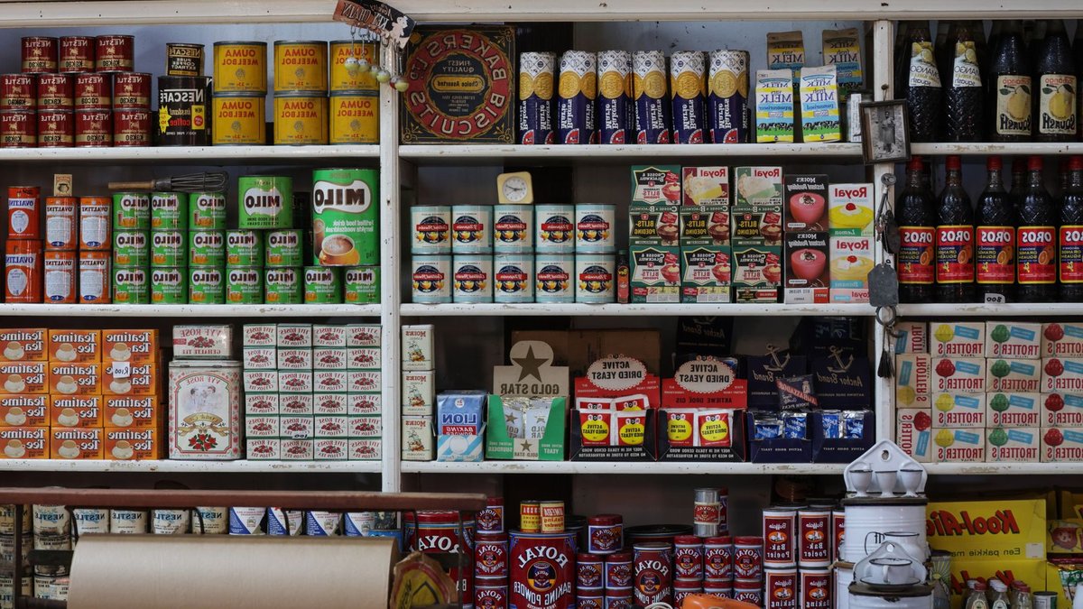 A vintage grocery store shelf filled with retro products and packaging from various brands.