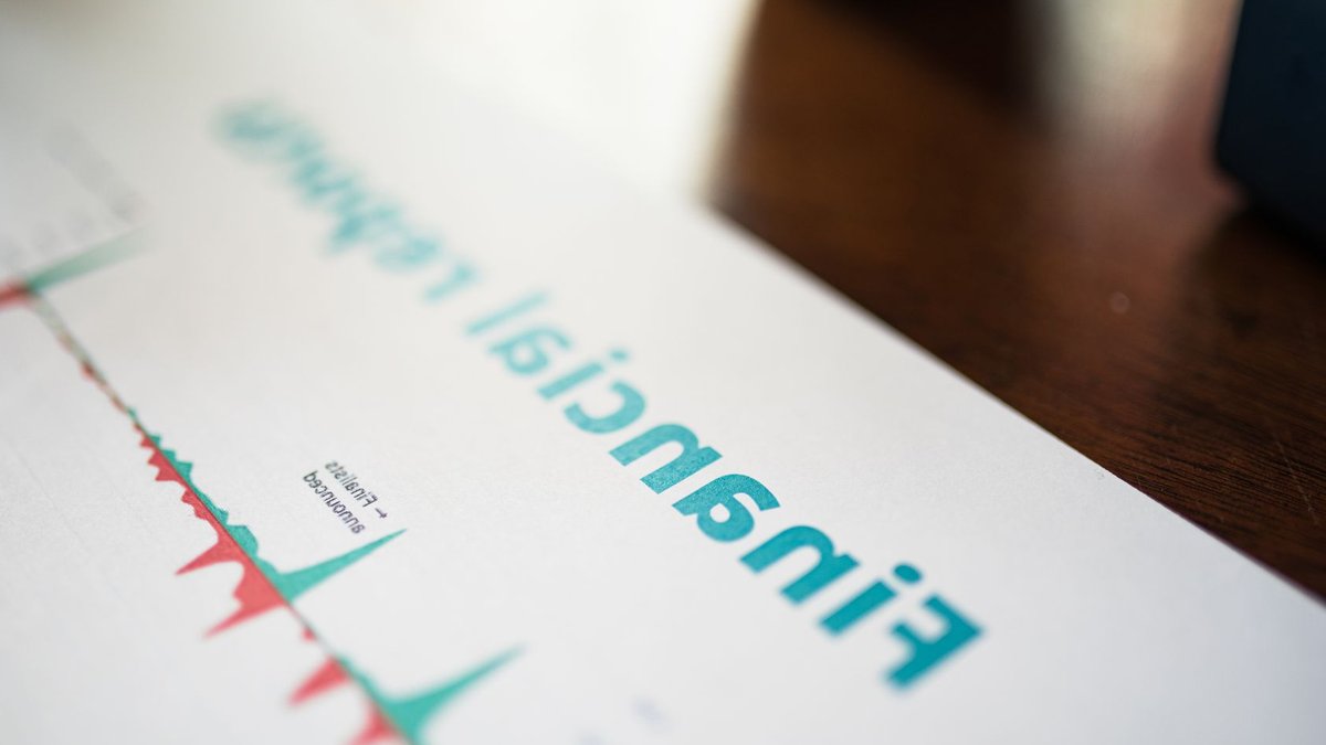 UK regulators oversee big tech companies directly Detailed view of a financial report with a focus on graphs and data analysis.