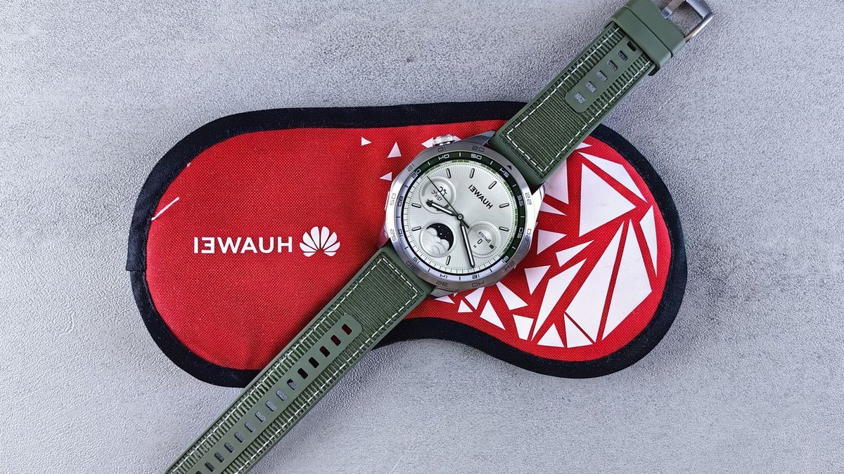 Top view of a Huawei smartwatch with green straps displayed on a red protective case. Perfect for tech enthusiasts.