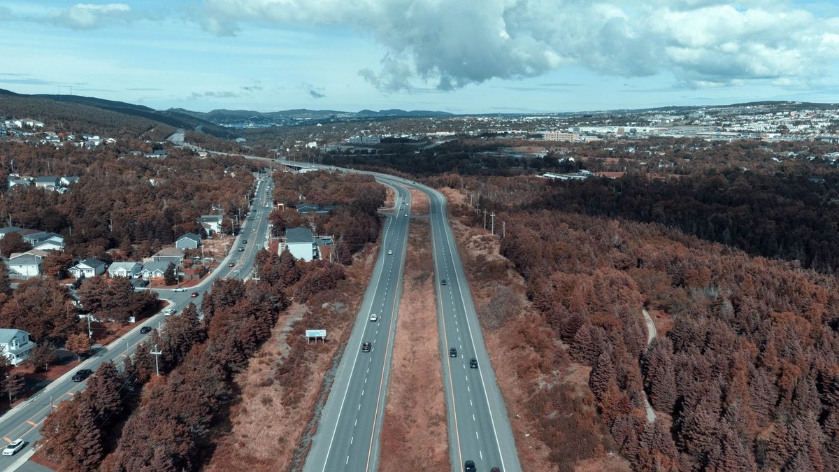 Nigerian leaders push to bridge rural digital divide Stunning aerial shot of a highway cutting through a vast rural landscape with cloudy sky.