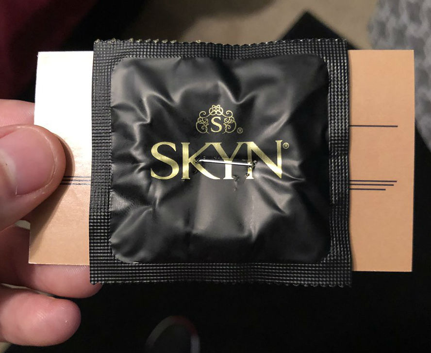 Personally, We Can't Trust This Barber Who's Stapling Condoms To His Business Cards