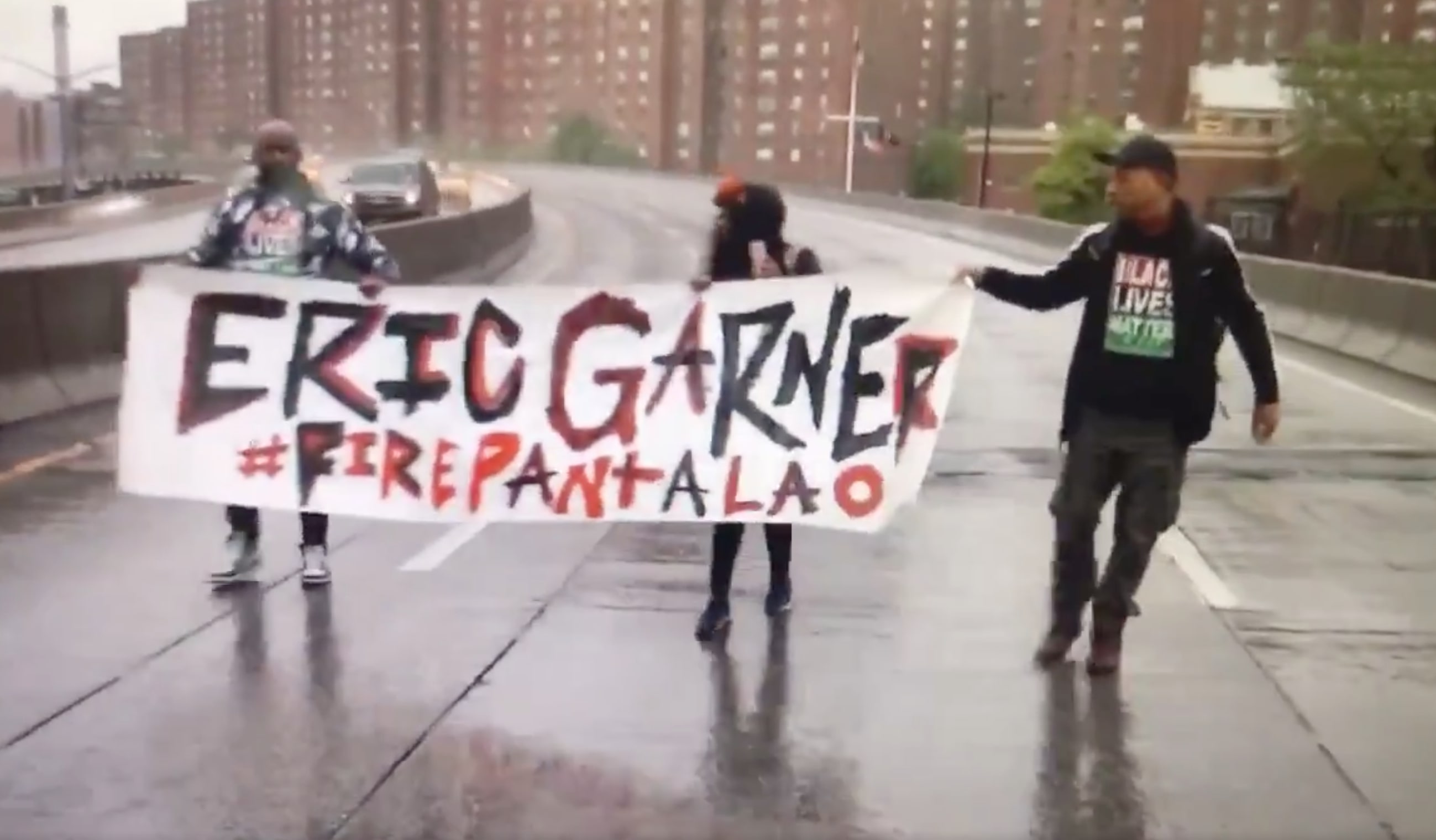 Protestors March In The Rain As Eric Garner's Killer Goes To Trial Five Years After Putting The Black Father In A Fatal Chokehold