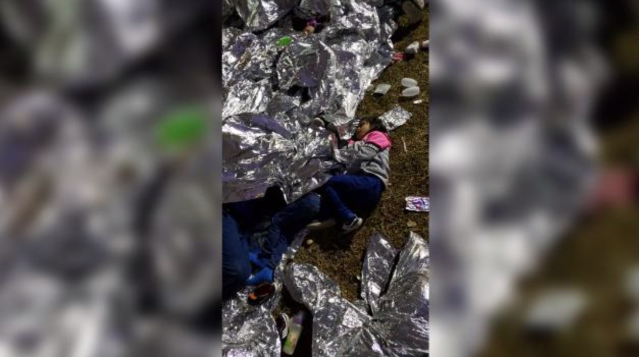 Leaked Photos Show Migrant Children Sleeping Outside Atop Nothing But Grass And Dirt