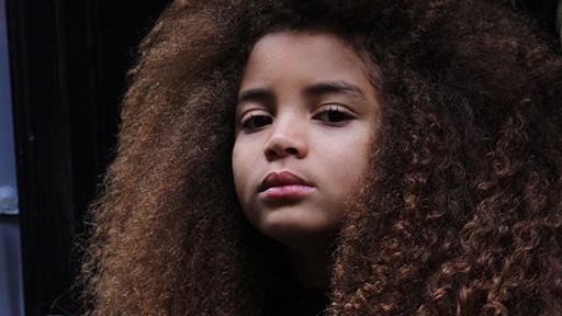 african american 8 year old girl. Brown curly hair .