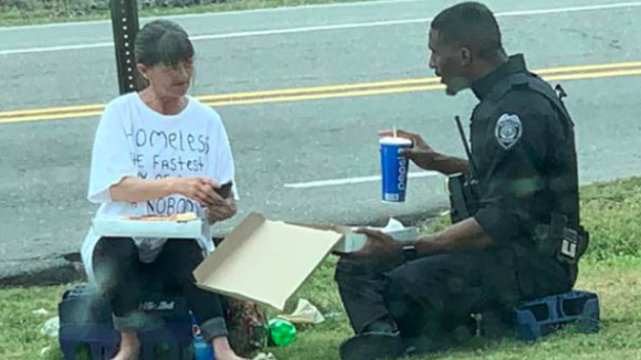 Touching Photo Of Black Officer Offering An Act Of Kindness To Homeless Woman Goes Viral