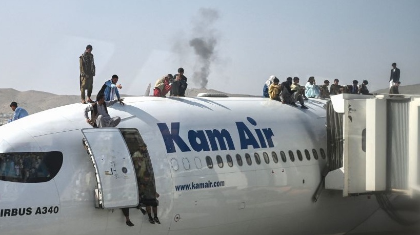 Disturbing Footage Shows Afghans Clinging To Moving Plane To Flee Country