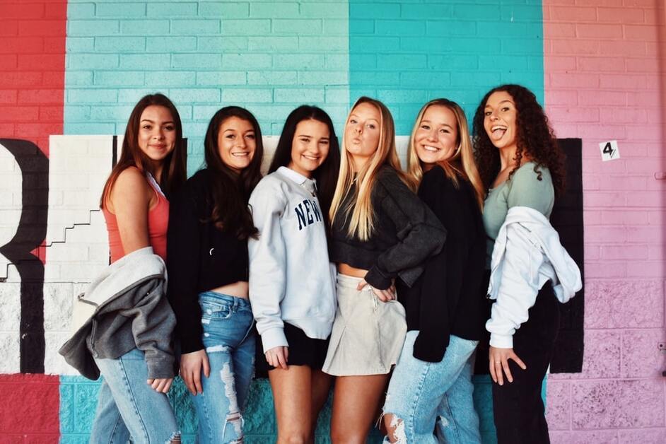 amigas adolescentes tirando foto em parede colorida