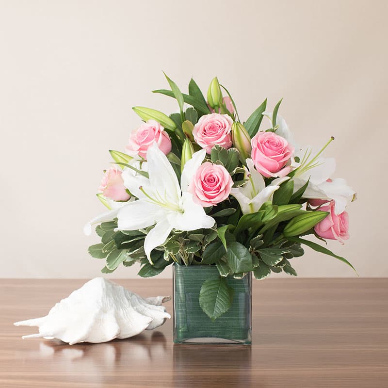 A truly gorgeous piece featuring stargazer lilies and premium roses, this has