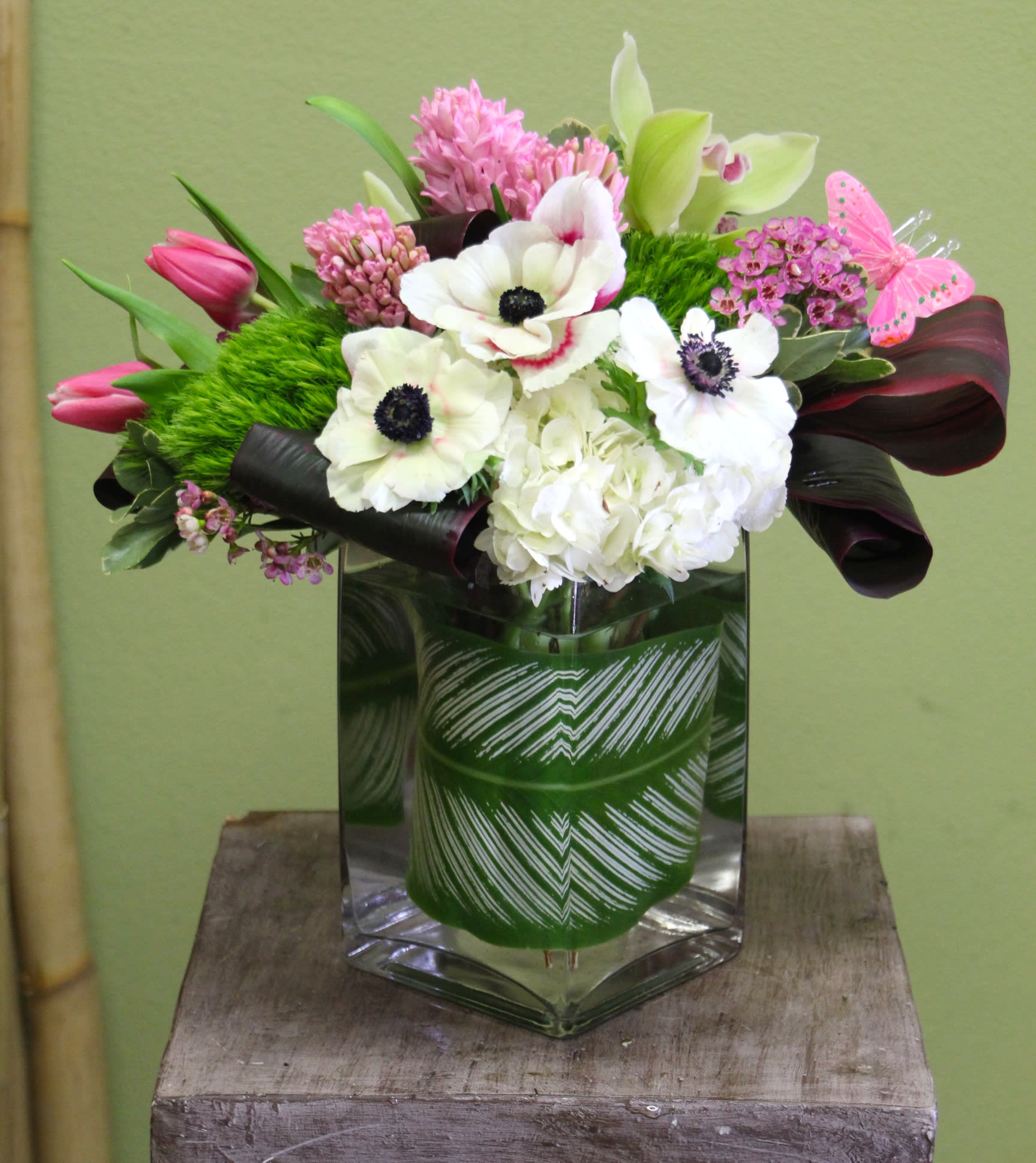 Justine Unique floral arrangement, tulips, orchids, ti leaves in