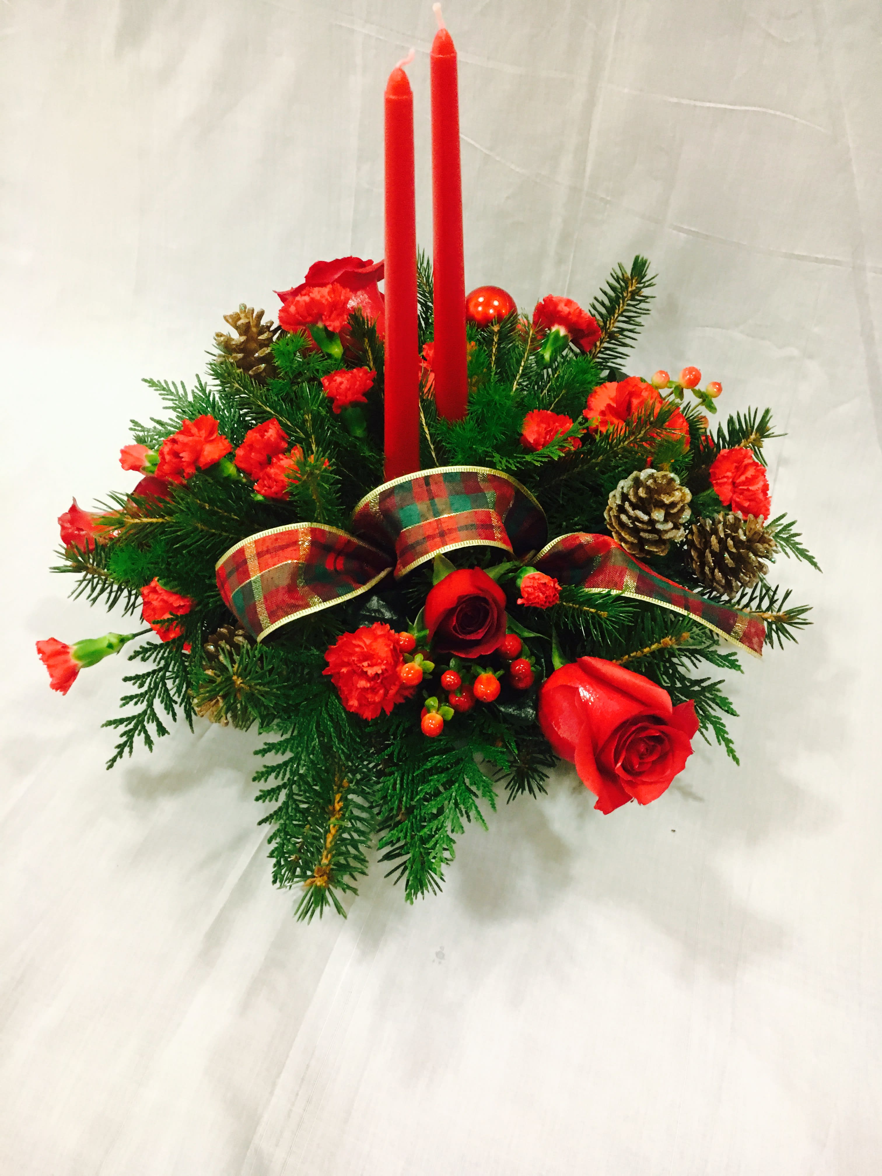 New Years Arrangement Red And Greens With Candles In Portland