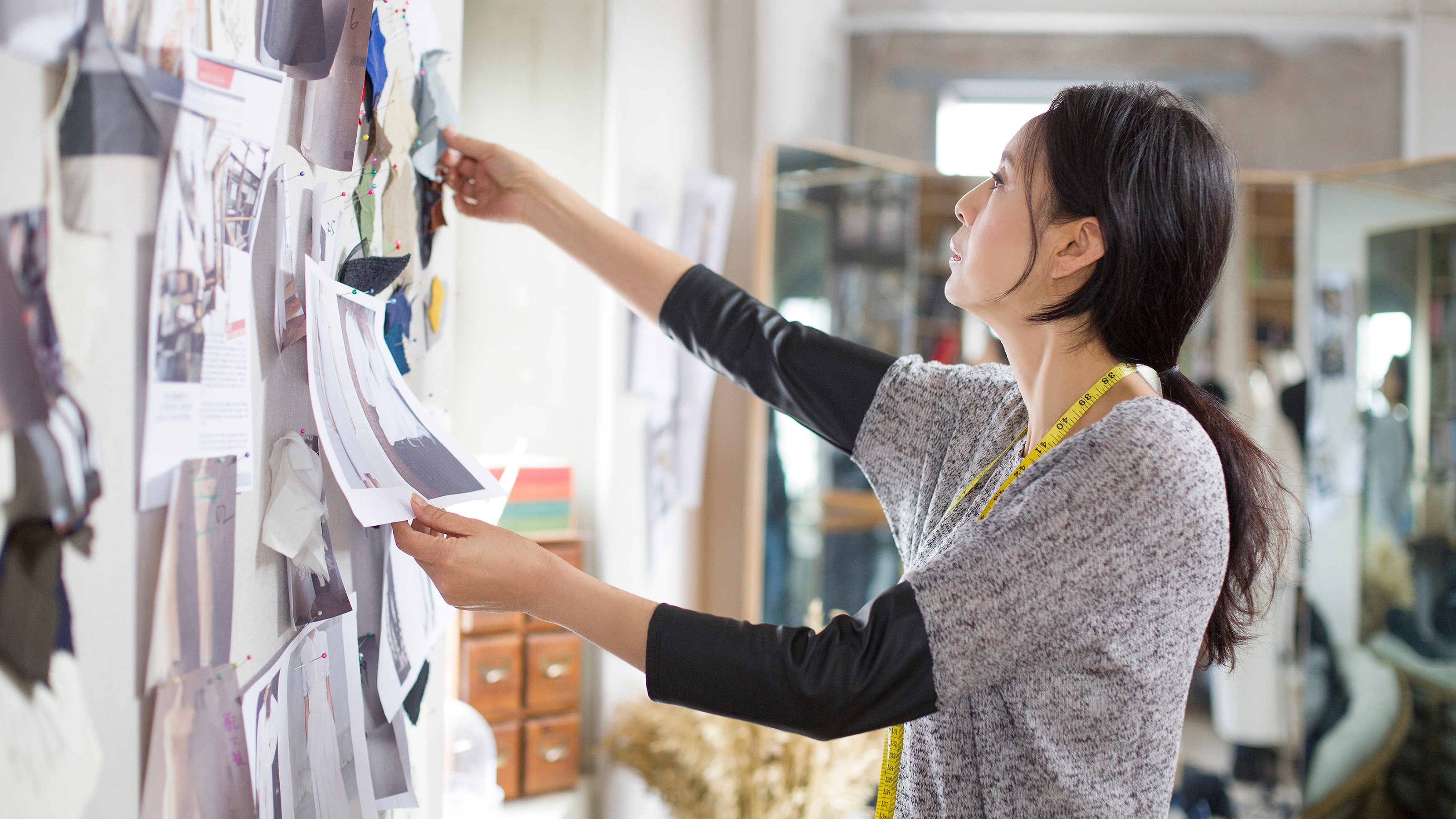 Designer in front of a vision board