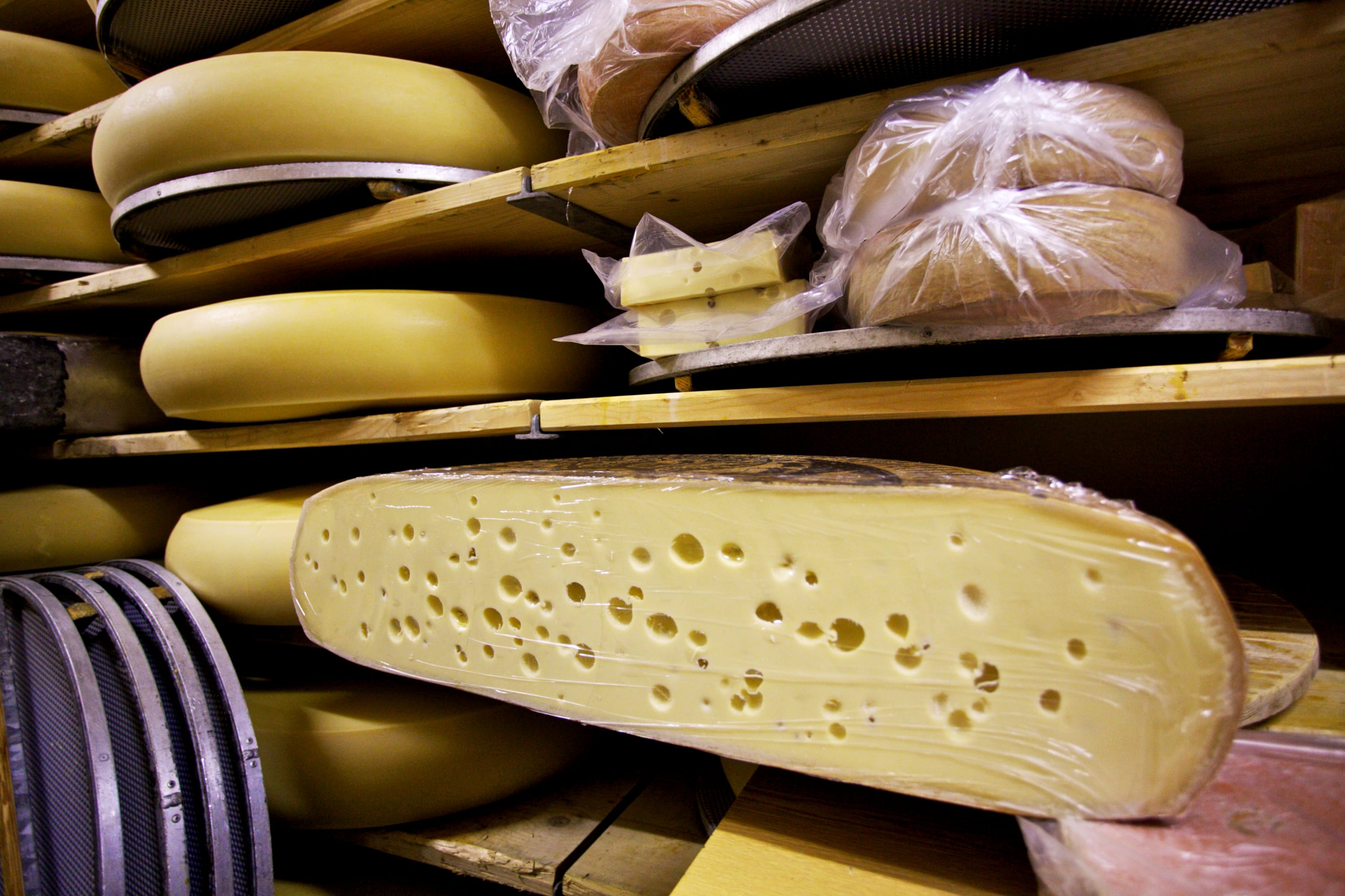Gotthelf Emmentaler, a special variant of Emmental cheese, sits on storage racks in the fermenting cellar at the Hupfenboden dairy in Hupfenboden, near Trubschachen, Switzerland, on Monday, Nov. 7, 2011.