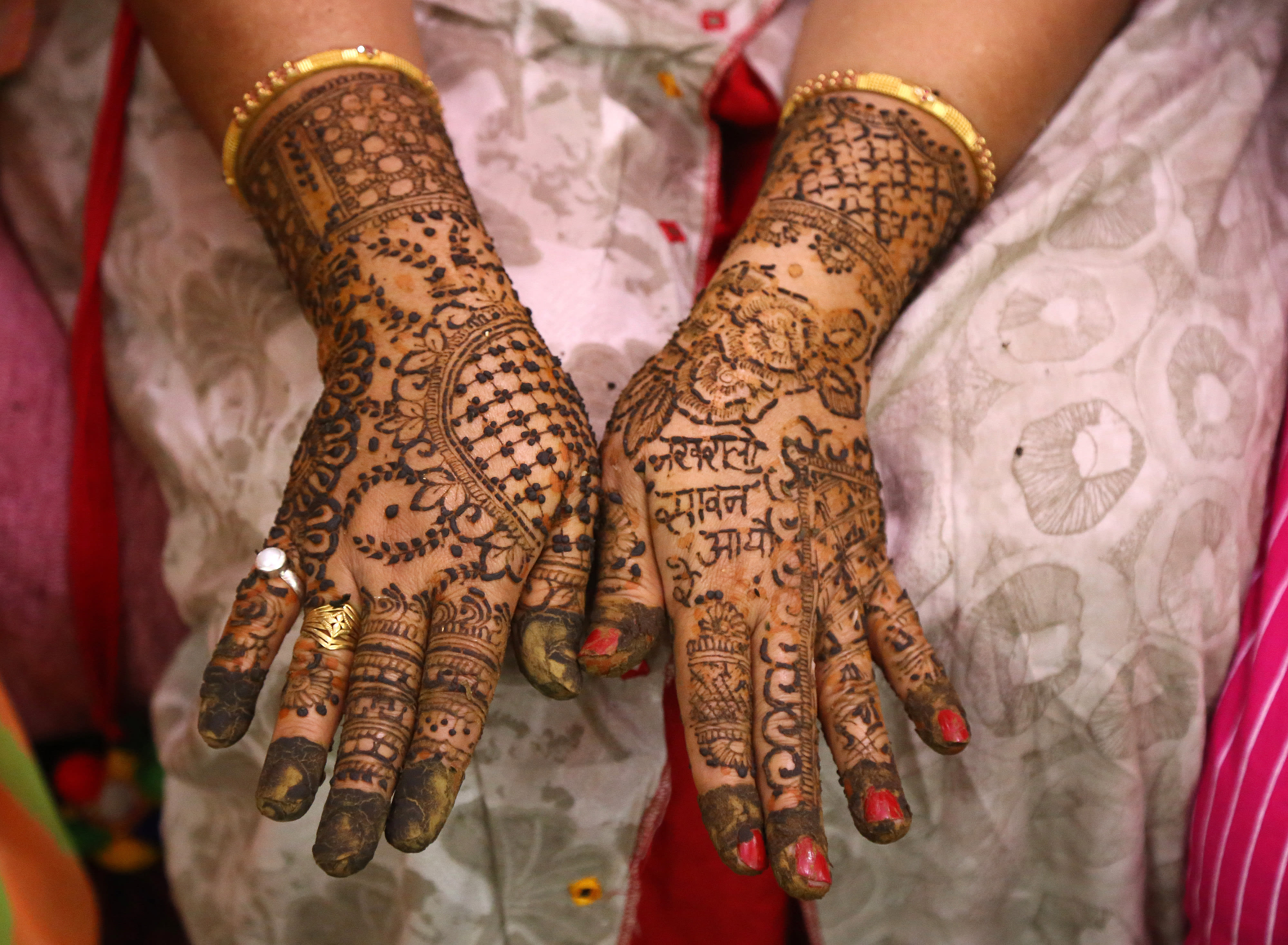 Indian woman displays her henna'd hands