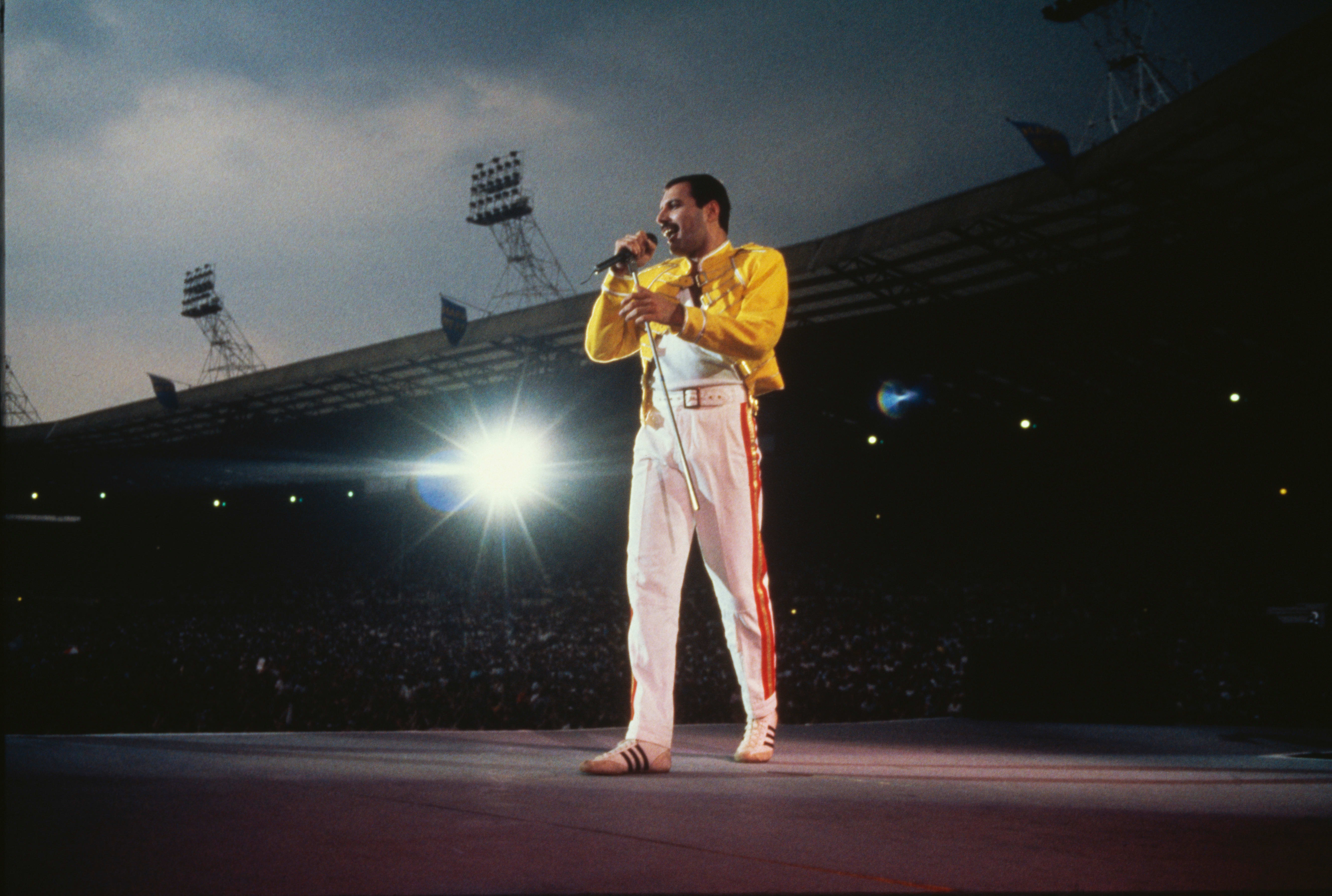 Singer Freddie Mercury performing with Queen at Wembley Stadium