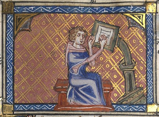 Picture showing an author writing at his desk