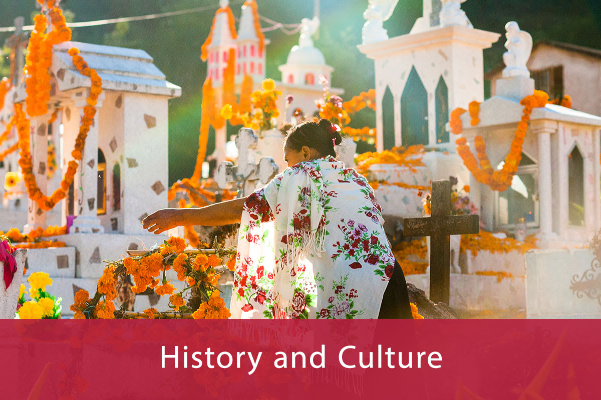 A Mixtec indigenous woman decorates a tomb at a cemetery during the Day of Dead celebrations on November 2, 2021 in Xalpatláhuac, Mexico.