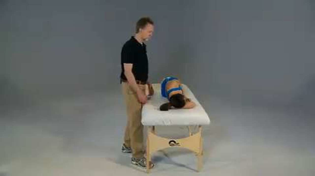 Rhomboids and Middle Trapezius Partner Stretch, Side-Lying on a Treatment Table